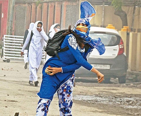 A girl student pelts a stone at security personnel during clashes near Lal Chowk in Srinagar on Monday | PTI