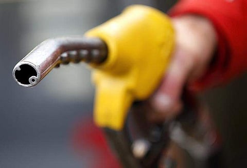 An attendant prepares to refuel a car at a petrol station . REUTERS