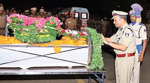 A CRPF official pays his last respects to Alagupandi at the Madurai airport