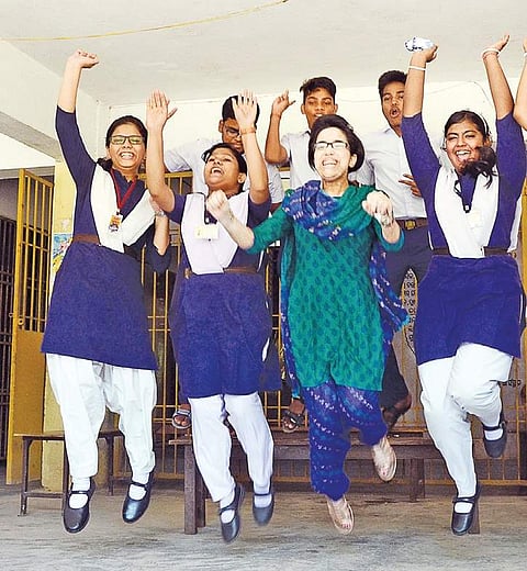 Students jump in joy after the announcement of HSC results at Unit 3 Saraswati Sishu Mandir in Bhubaneswar on Wednesday | Express
