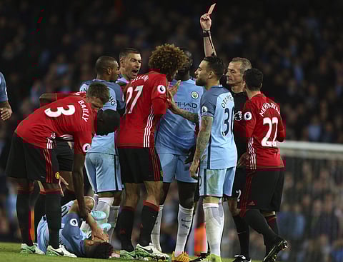Manchester United's Marouane Fellaini, center, is sent off by given a red card during the English Premier League soccer match between Manchester City and Manchester United at the Etihad Stadium in Manchester, England,Thursday, April 27, 2017. | AP
