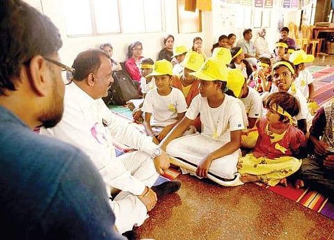Corporator S G Nagaraj with children at the grama sabha