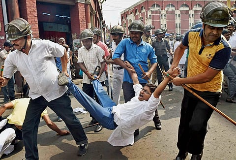 Police detain a Congress activist during a protest against TMC leaders involved in the Narada scam, in Kolkata on Thursday (File | PTI)