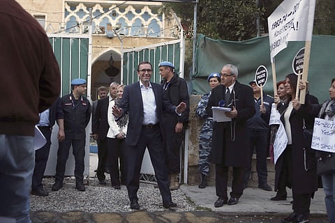 U.N. Special Advisor of the Secretary-General Espen Barth Eide, center, addresses protesters outside the main gate of Ledras Palace, where a dinner for ethnically divided Cyprus' rival leaders will be held, inside the U.N buffer zone in the divided capita