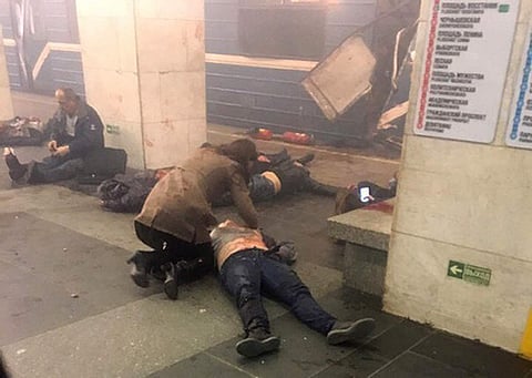 Blast victims lie near a subway train hit by a explosion at the Tekhnologichesky Institut subway station in St.Petersburg, Russia, Monday, April 3, 2017. | AP