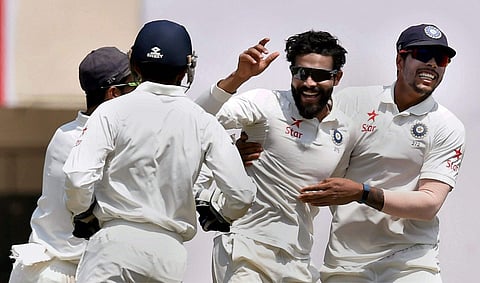 Indian player Ravindra Jadeja celebrates with teammates after the dismissal of Australian skipper Steven Smith during during 5th day of 3rd Test Match in Ranchi on on Monday. | PTI