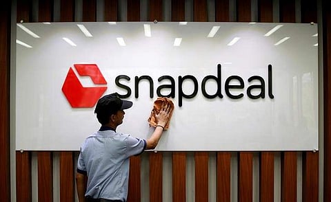 An employee cleans a Snapdeal logo at its headquarters in Gurugram on the outskirts of New Delhi, India April 3. (File Photo | Reuters)