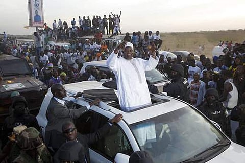 Gambian President Adama Barrow, waves as he rides his motorcade through crowds of hundreds of thousands. (File photo | AP)