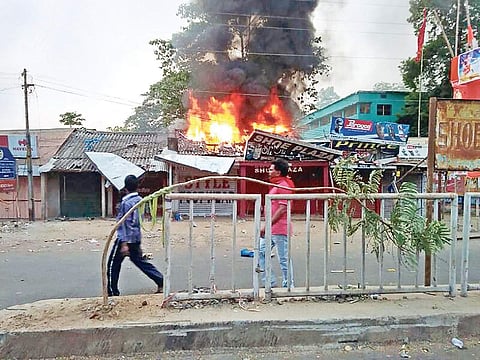 A shop set on fire as tension flares up in Bhadrak on Friday. The town wore a deserted look with people remaining indoors | Express