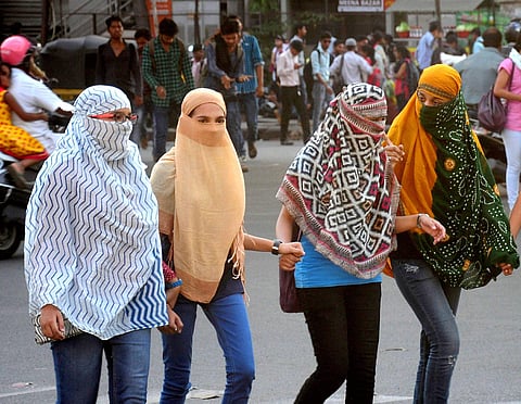 Girls cover their faces to get protection from scorching heat during a hot day in Nagpur Maharashtra. | PTI