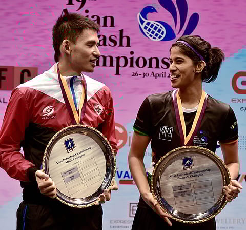 Women's and Men's winners India's Joshna Chinappa and Hong Kong's Max Lee L pose with their trophies after the 19th Asian Squash Championship in Chennai on Sunday. (Photo | PTI)