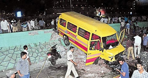 The private school bus which swerved off the road owing to an alleged brake failure and jumped the parapet wall on the Beach Road in Visakhapatnam on Sunday evening | Express
