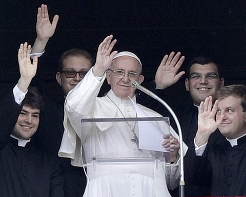 Pope Francis flanked by four newly ordained priests wave to faithful during the Regina Coeli prayer in St. Peter's Square, at the Vatican, Sunday, May 7, 2017. (File|AP)