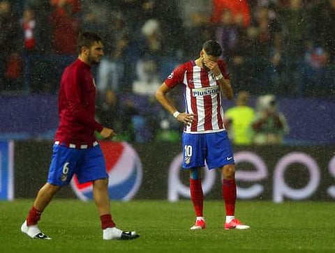 Atletico's Yannick Carrasco, right, looks dejected at the end of a Champions League semifinal, 2nd leg soccer match between Atletico de Madrid and Real Madrid. | AP