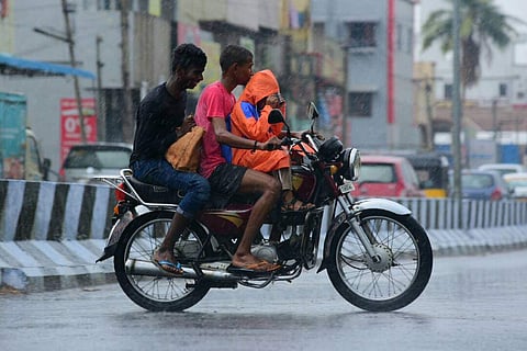 Chennai got some respite from the 'kathiri' heat as brief spells of rain were observed in parts of the city on Thursday morning. Commuters were seen riding through the rain with their raincoats on and their umbrellas up. (EPS | Sunish P Surendran)