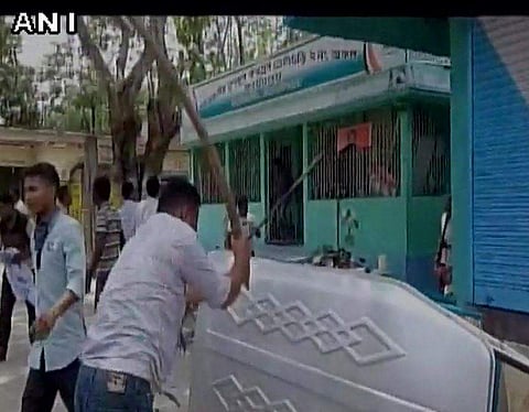 The TMC workers proceeded to vandalise the BJP workers’ car while the latter tore into their office.  | Picture Courtesy: ANI