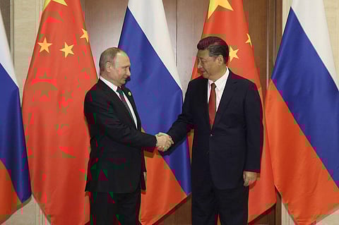 Russian President Vladimir Putin left shakes hands with Chinese President Xi Jinping prior to a bilateral meeting at Diaoyutai State Guesthouse in Beijing Sunday May 14 2017.