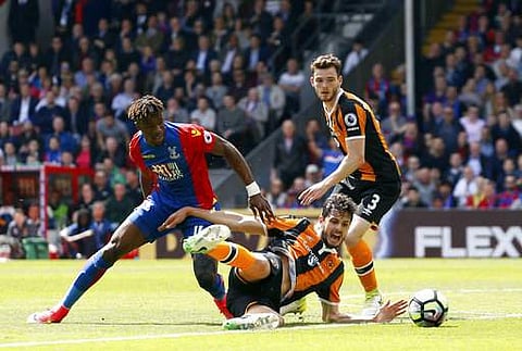 Crystal Palace's Wilfried Zaha, left and Hull City's Andrea Ranocchia battle for the ball during the English Premier League soccer match. | AP
