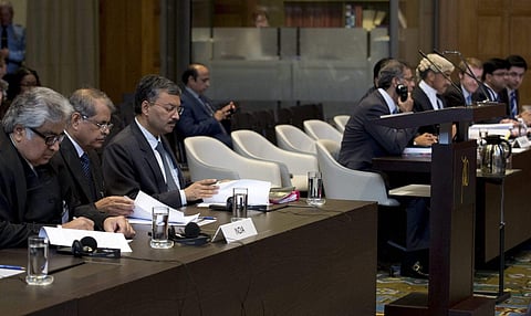 Delegations of India (left) and Pakistan wait for judges to enter the World Court in The Hague, Netherlands on Monday. (AP)