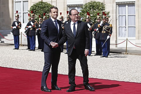 New French President Emmanuel Macron bids farewell to former French President Francois Hollande, right, after the inauguration ceremony at the Elysee palace in Paris, France, Sunday, May 14, 2017. | AP