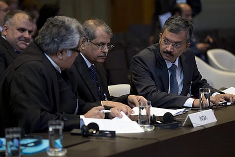 Dr. Deepak Mittal, joint secretary of India's Ministry of External Affairs, right, and his delegation wait for judges to enter the World Court in The Hague, Netherlands, Monday, May 15, 2017. | AP