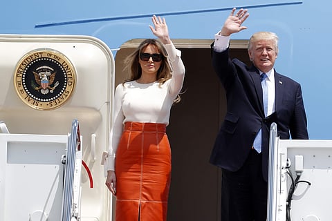 President Donald Trump and first lady Melania Trump, wave as they board Air Force One at Andrews Air Force Base, Md., Friday, May 19, 2017, prior to his departure on his first overseas trip. | AP
