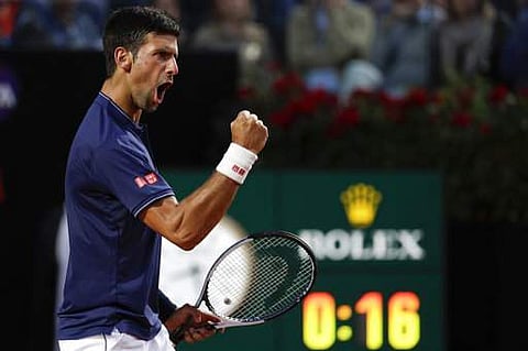 Serbia's Novak Djokovic celebrates after winning a point during his semifinal match match against Austria's Dominic Thiem at the Italian Open tennis tournament. | AP
