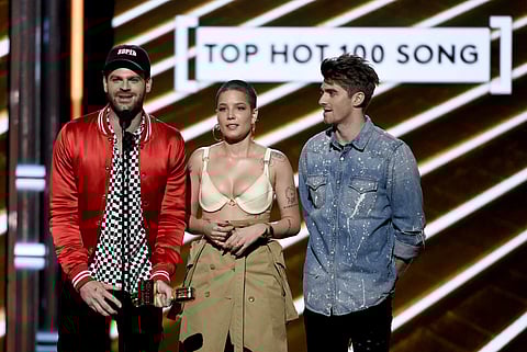 Alex Pall, left, and Andrew Taggart, right, of The Chainsmokers, and Halsey accept the award for top hot 100 song for 'Closer' at the Billboard Music Awards at the T-Mobile Arena on Sunday, May 21, 2017, in Las Vegas.(AP)