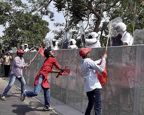 Left Front activists attack police personnel during a protest rally in Kolkata on Monday. | PTI