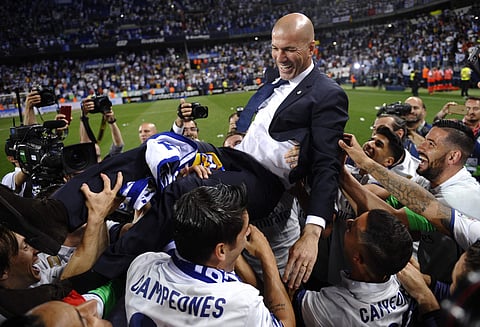 Real Madrid's head coach Zinedine Zidane is thrown into the air by his players after winning a Spanish La Liga soccer match between Malaga and Real Madrid in Malaga, Spain, Sunday, May 21, 2017.