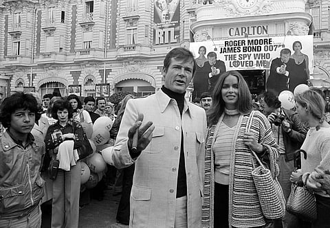 On May 20, 1977, Roger Moore is accompanied by co-star Barbara Bach as they arrive for the screening of their latest 007 feature, 'The Spy Who Loved Me,' during the Cannes Film Festival at the French Riviera. Moore died on May 23 in Switzerland after batt