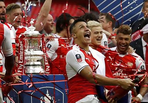 Arsenal's Alexis Sanchez celebrates winning the English FA Cup final soccer match between Arsenal and Chelsea at the Wembley stadium in London. | AP