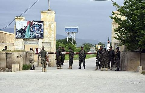 (File Photo for representation | AP) Afghan soldiers stand guard at the gate of a military compound after an attack by gunmen in Mazar-e- Sharif province north of Kabul.