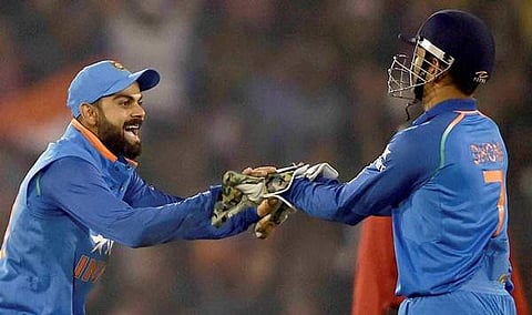 Indian captain Virat Kohli and M S Dhoni celebrate the wicket of England batsman BA Stokes during the 2nd ODI match at Barabati stadium in Cuttack on January 19. (Photo | PTI)