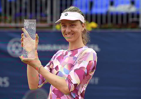 Mona Barthel of Germany poses with a trophy after winning the Prague Open Tennis Tournament final match against Kristyna Pliskova of Czechia in Prague. | AP