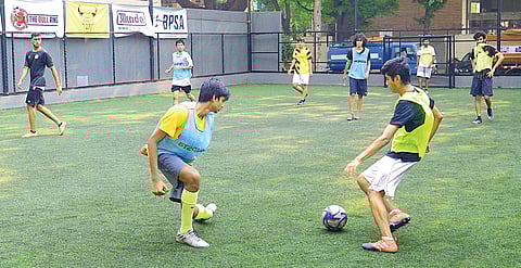 Young men playing a match at Bull Ring futsal court, Indiranagar  Pushkar V