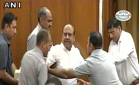 BJP MLA Vijendra Gupta marshaled out of the Delhi Assembly. (ANI)