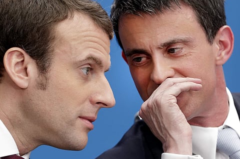 Then Prime Minister of France Manuel Valls, right, speaks with then economy minister Macron during in Paris. (File|AP)