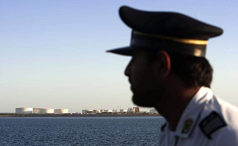 A security personnel looks on at oil docks at the port of Kalantari in the city of Chabahar. (Photo