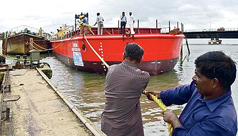 The workers of Kerala Shipping and Inland Navigation Corporation taking the new barge to the backwaters for a trial run after the launching ceremony at Thoppumpady Fisheries Harbour on Friday | Albin Mathew