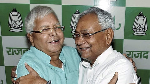 Bihar Chief Minister Nitish Kumar greets RJD Chief Lalu Prasad Yadav at his residence in Patna.