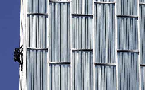 French urban climber, Alain Robert, also known as 'French Spiderman', scales the 120 meters (393 ft) Melia Barcelona Sky Hotel in Barcelona, Spain, Monday, June 12, 2017. | AP