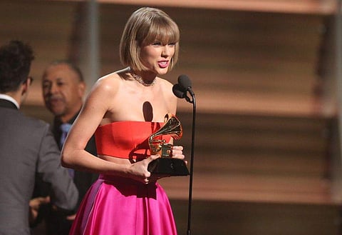 Taylor Swift accepts the award for album of the year for “1989” at the 58th annual Grammy Awards.