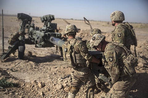 U.S. Soldiers with Task Force Iron maneouvre an M-777 howitzer, so it can be towed into position at Bost Airfield, Afghanistan. (File photo | AP)
