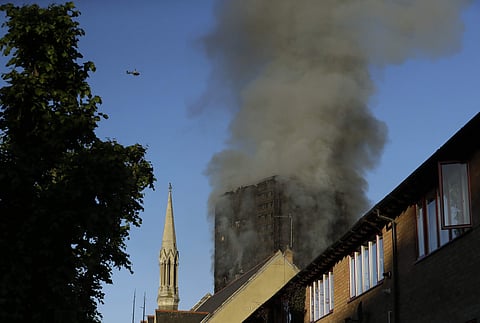 Smoke rises from a 27-floor high-rise apartment building on fire in London. (File photo | AP)