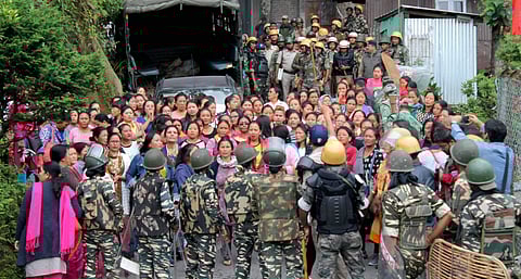 Security forces personnel trying to control woman Gorkha Janamukti Morcha GJM supporters during a protest at their office Patlebash in Darjeeling on Thursday. (File | PTI)