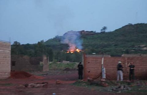 Fire can be seen by the swimming pool of the Campement Kangaba, a tourist resort near Bamako, Mali, Sunday, June 18, 2017. | AP