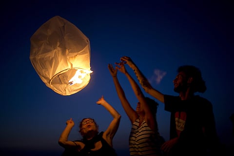 Activists release paper lanterns in solidarity with Palestinians from Gaza, at the Ashkelon beach front, Israel, Monday, June 19, 2017. Israel's national electric company on Monday cut back its already limited electricity shipments to the Gaza Strip in a 