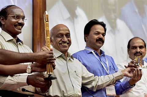 Indian Space Research Organisation ISRO chairman Kiran Kumar Rao displays the model of the PSLV C38 along with other scientists at a press conference after the launch of the earth observation satellite Cartosat-2 Series in Sriharikota on Friday. | PTI