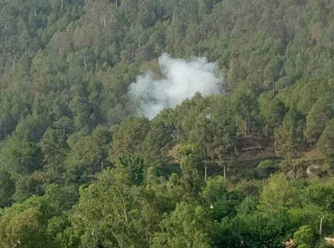 Smoke billows out from a forest after mortar shells were allegedly fired by Pakistani army in Naushera sector near the Line of Control LoC in Rajouri district. | PTI